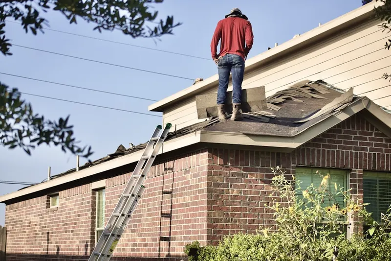 Professional roofer working on a residential roof in Rockaway
